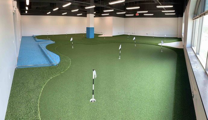 Indoor golf field with synthetic grass
