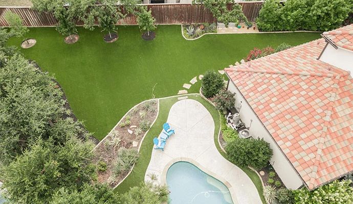 Installed artificial turf near trees in residential front yard