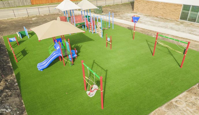 Aerial view of a new school playground with artificial turf