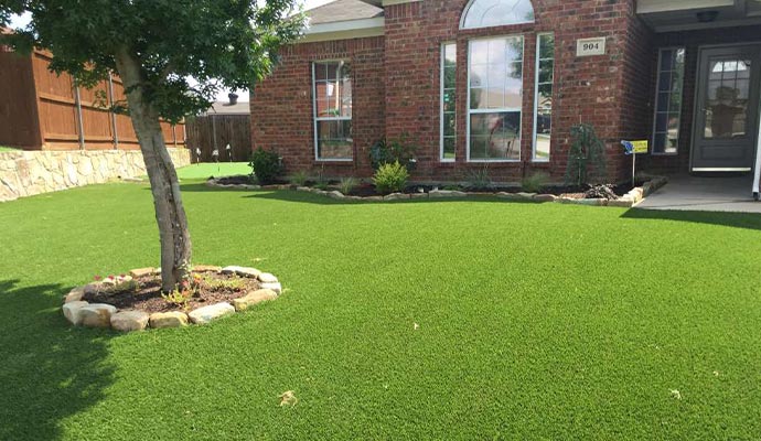 Artificial turf front lawn Residential front yard with a perfect artificial turf lawn.